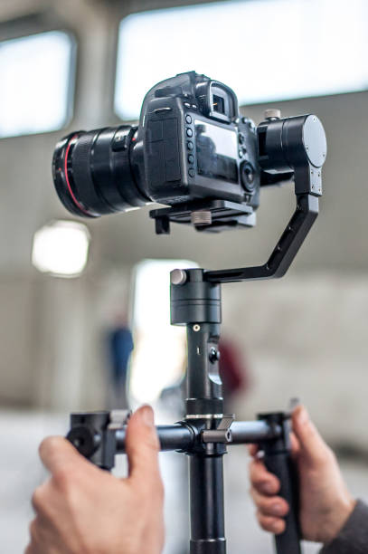 istock Man hand holding camera and take the photo 1141991891