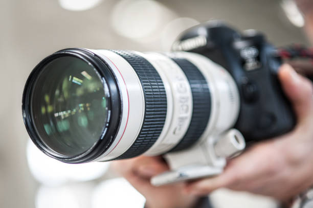 istock Man hand holding camera and take the photo 1141991944