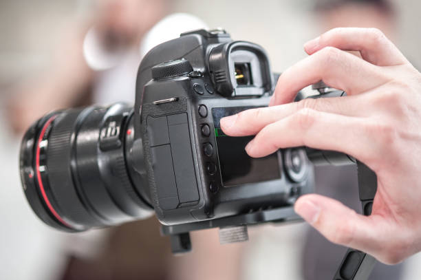 istock Man hand holding camera and take the photo 1141992045