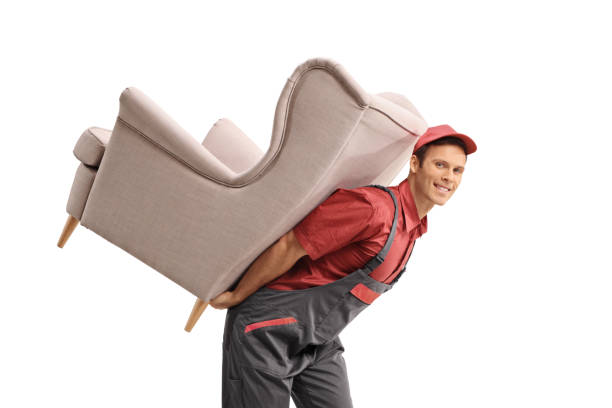istock Young over carrying an armchair on his back 1141993307