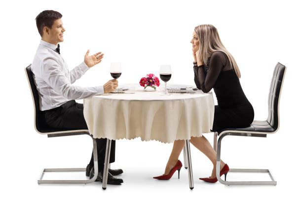 istock Young man talking to a young woman at a restaurant table 1141993325