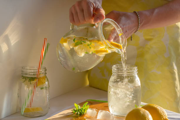 istock fresh homemade lemonade, pour in a glass 1141994445