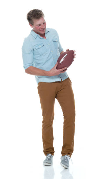 istock Casually dressed man holding a football 1141994584