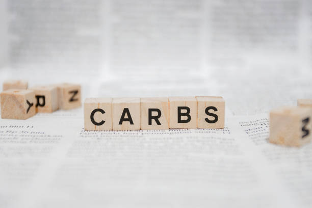 istock Carbs Word Written In Wooden Cube - Newspaper 1141995635