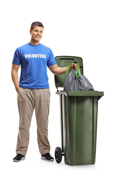 istock Young man volunteer throwing waste in a bin 1141995641