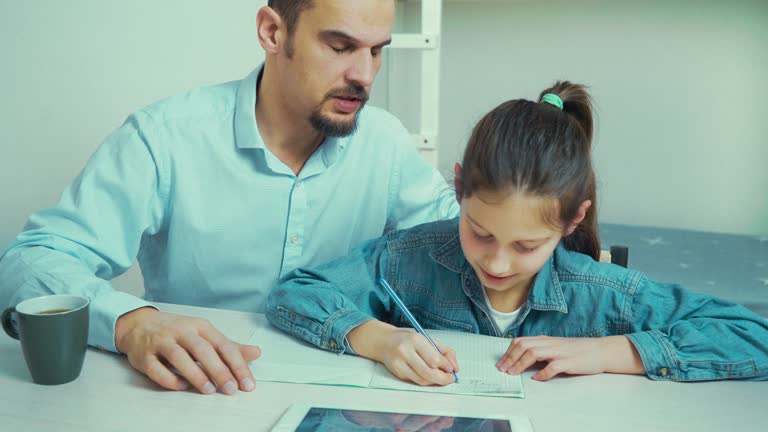 strict father is angry with his daughter doing homework