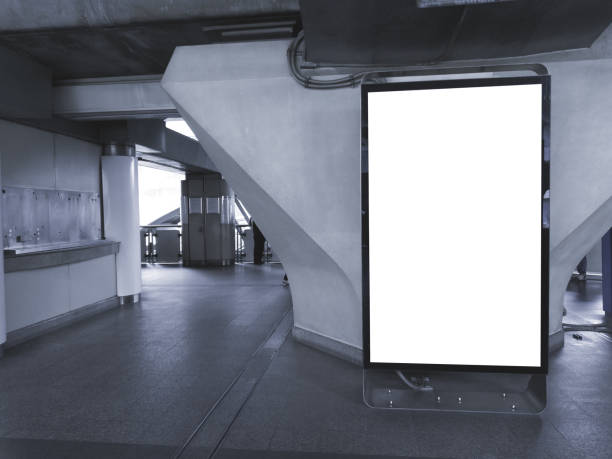 istock large blank advertise billboard white LED screen vertical on big concrete pole walk way outdoor in city. 1141997631