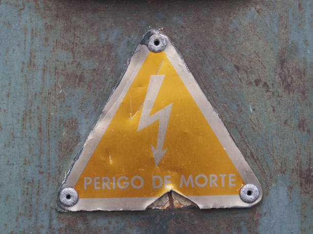 istock an old metal triangular yellow Portuguese electricity safety sign with a lightning bold symbol reading perigo de morte - translation danger of death on a rusty metal background 1141997868