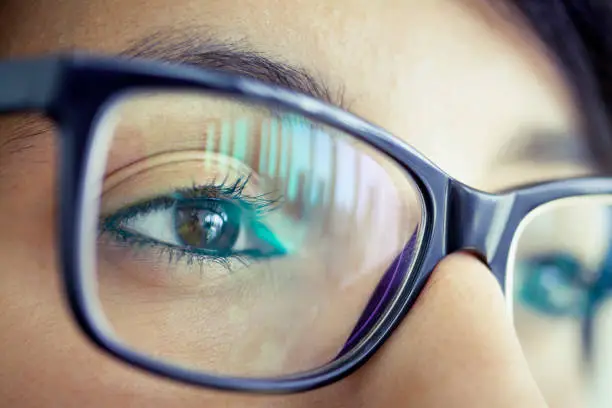 Photo of Young woman with eyeglasses, close-up of eye