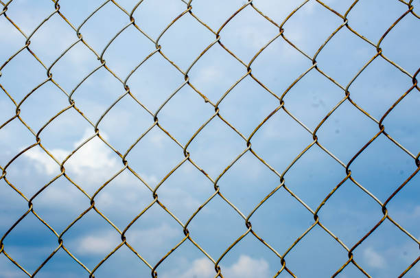 Metal fence with cloud background
