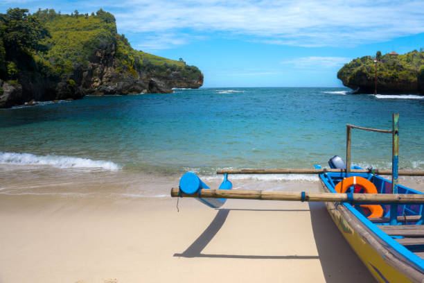 istock fishing boats that are pulling over on the beach 1142000476