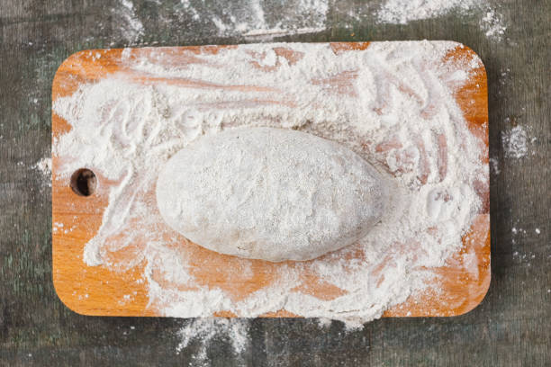 istock Dough in flour for rye bread on a wooden board 1142001122