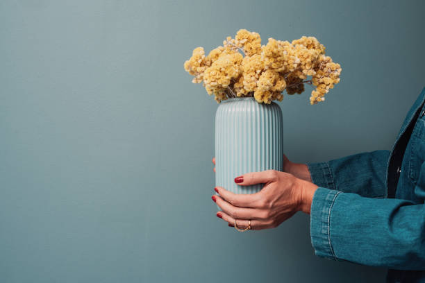 istock Vase with dried yellow flowers immortelle 1142001153