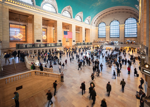 Motion blur as passengers and visitors walk through the huge interior of Grand Central Station in Manhattan, New York City.