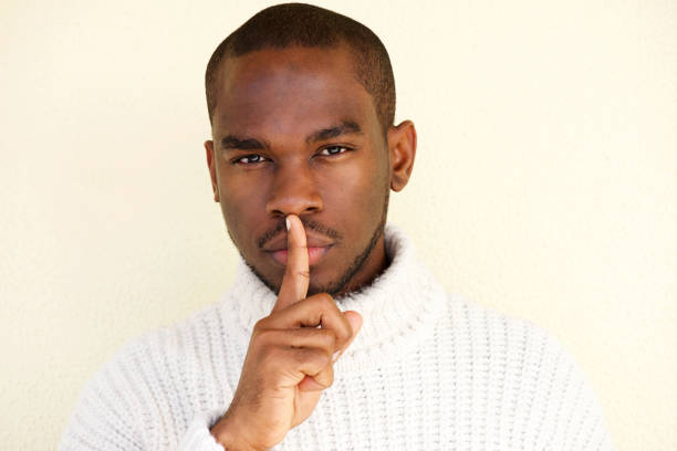istock Close up african american man with finger over lips 1142004015