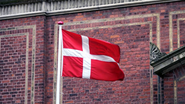 Danish flag with brick wall background in copenhagen Denmark Danish flag with brick wall background in copenhagen Denmark ribe town photos stock pictures, royalty-free photos & images