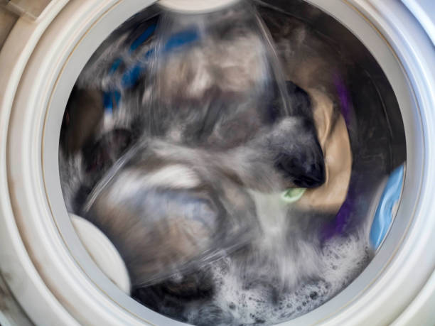 istock Top loading washing machine washes laundry. Internal view of a washing machine drum during wash. Top view. 1142004280