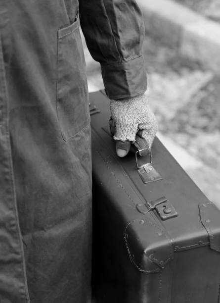 istock poor man with old leather suitcase and gloves  with black and wh 1142005459