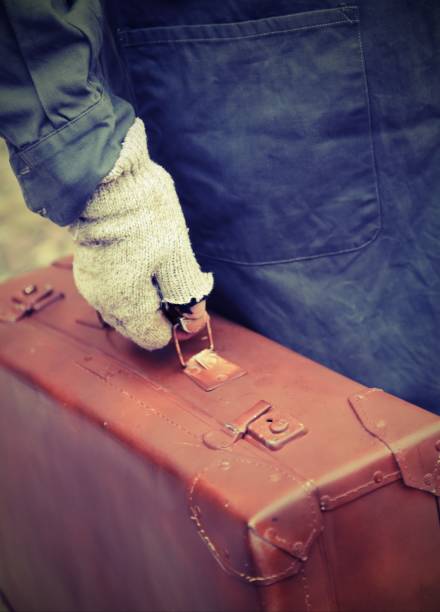 istock poor man with old leather suitcase during the trip abroad 1142005516
