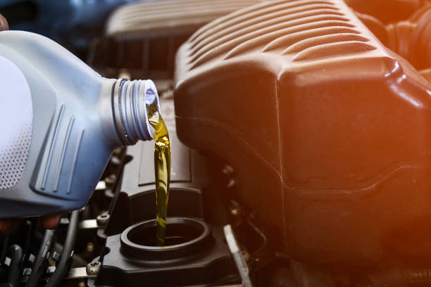 istock Pouring oil into the car engine, refueling 1142005615