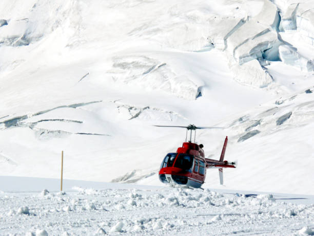 istock Red helicopter on high mountain snow 1142006696