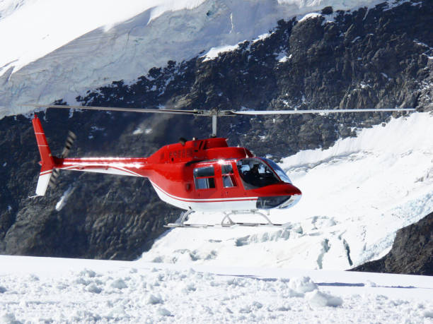 istock Red helicopter on high mountain snow 1142007345