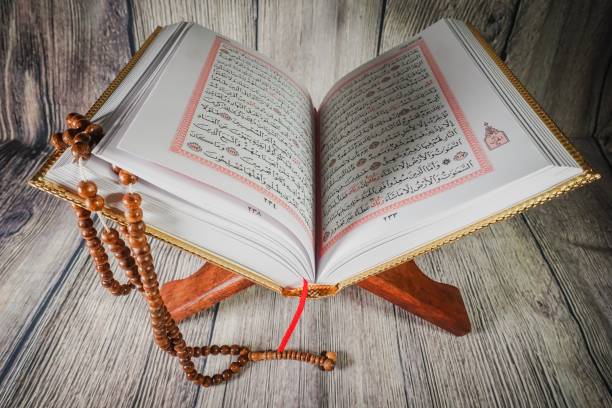istock Islamic concept: Quran (Koran, al-Quran) against wooden background 1142007364