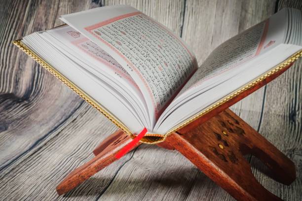 istock Islamic concept: Quran (Koran, al-Quran) against wooden background 1142007425