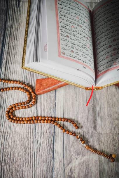 istock Islamic concept: Quran (Koran, al-Quran) against wooden background 1142007433