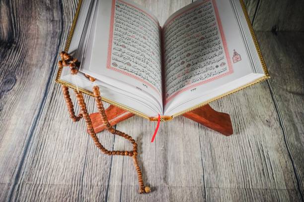 istock Islamic concept: Quran (Koran, al-Quran) against wooden background 1142007458