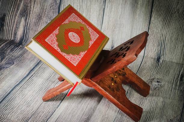 istock Islamic concept: Quran (Koran, al-Quran) against wooden background 1142007534