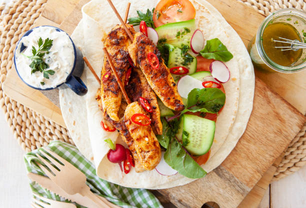 istock Grilled chicken skewers with fresh salad 1142008912