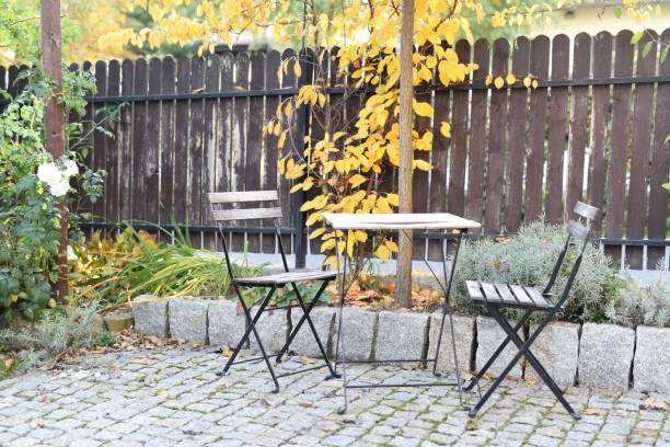 istock Chairs and table in an autumn garden 1142009058