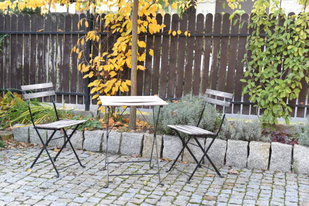 istock Chairs and table in an autumn garden 1142009064