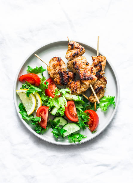 istock Turkey skewers and vegetables fresh salad on a light background, top view 1142009074