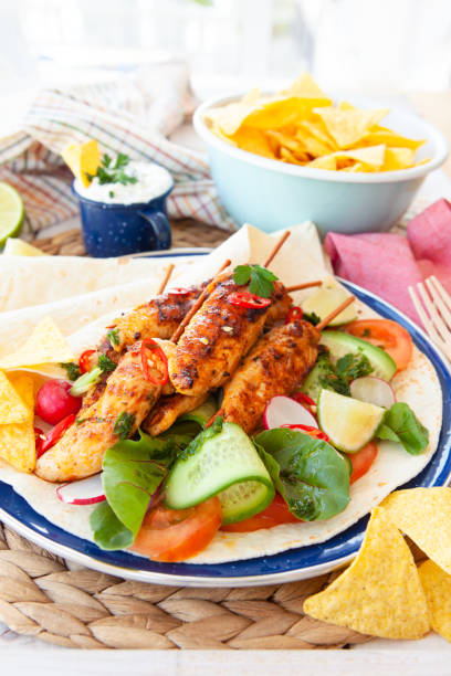 istock Grilled chicken skewers with fresh salad 1142009217