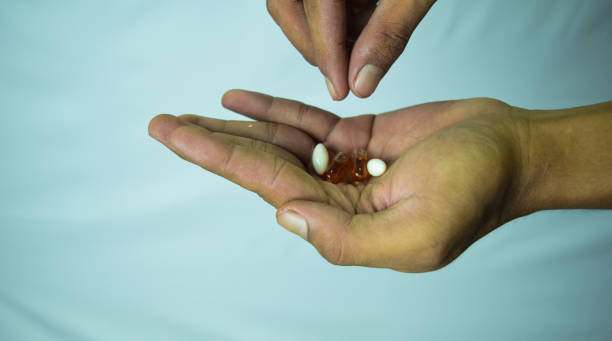 istock Close-up of capsule in hand white background. 1142009518