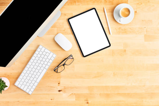 istock Modern workspace with large desktop computer and tablet on wooden office desk 1142010546