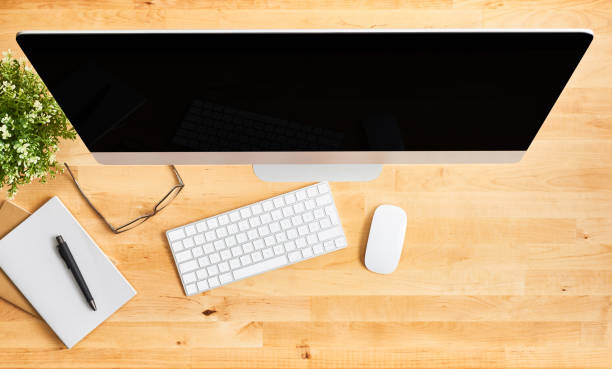 istock Top view of large desktop computer on wooden office desk 1142010584