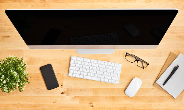 istock Top view of large desktop computer on wooden office desk 1142010683