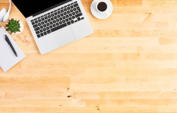 istock Top view of laptop computer on wooden office desk 1142010772