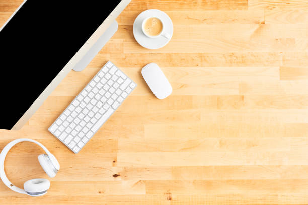 istock Top view of large desktop computer on wooden office desk 1142010879