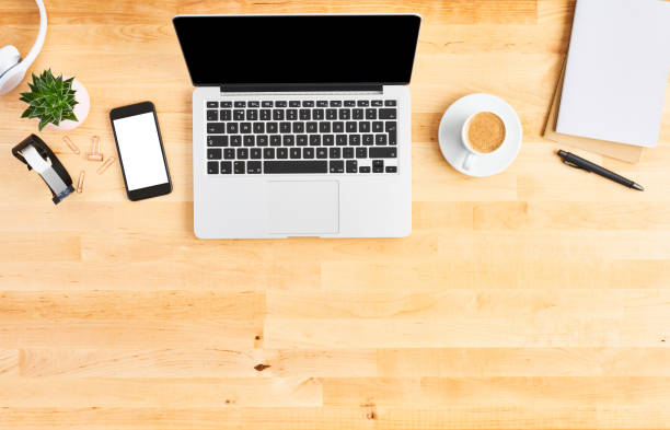 istock Top view of laptop computer on wooden office desk 1142010941