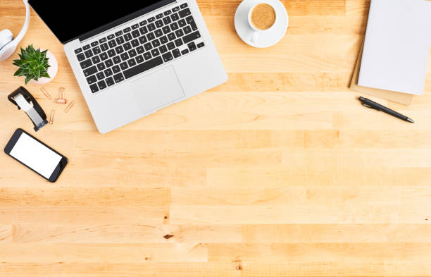 istock Top view of laptop computer on wooden office desk 1142010948