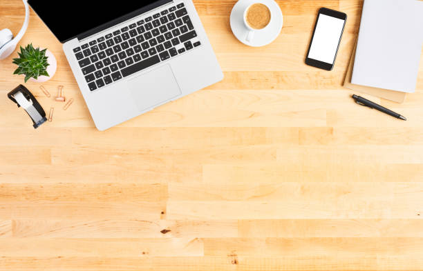 istock Top view of laptop computer on wooden office desk 1142010952