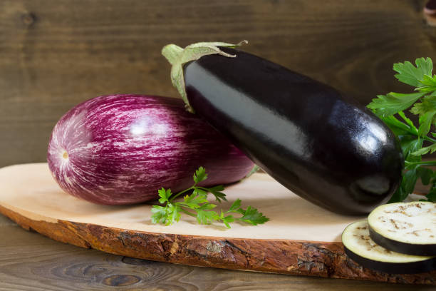 istock Two organic fresh eggplants on wooden background 1142012088