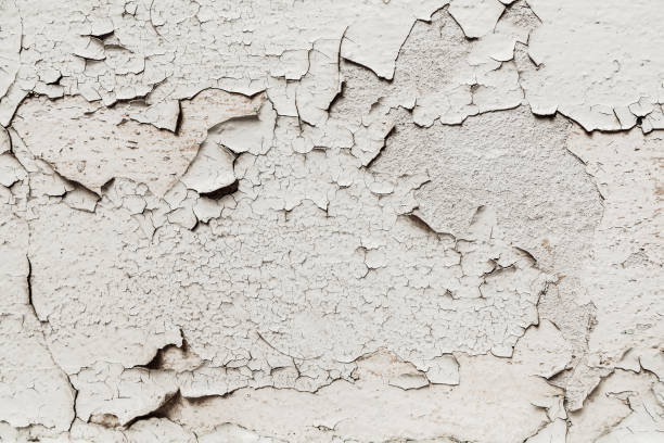 istock Old cracked white paint on the wall background 1142012520