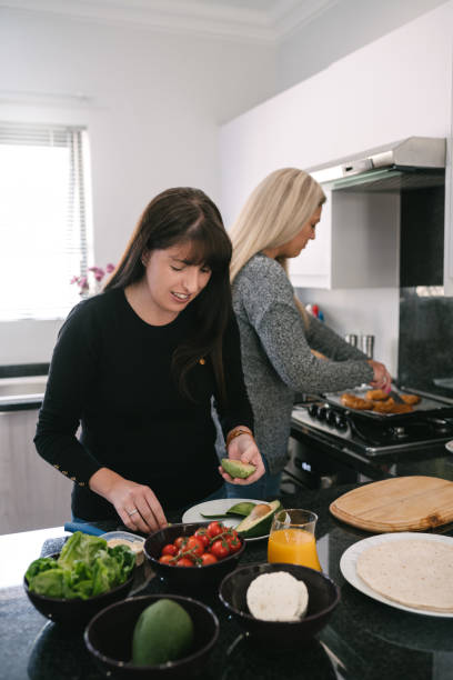 istock Lesbian couple preparing and making food in the kitchen 1142012666