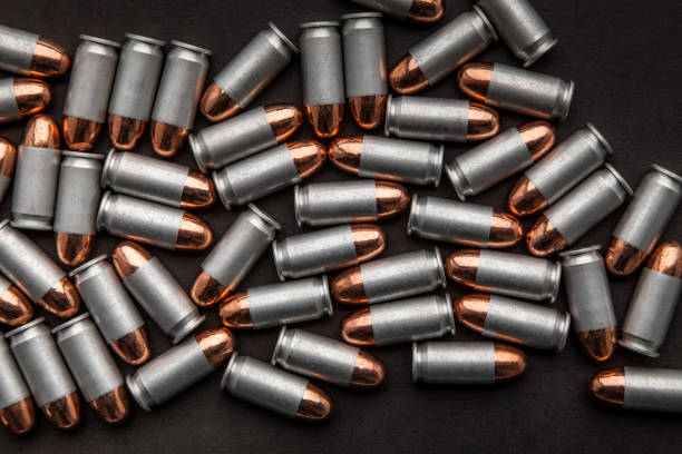 istock cartridges for a pistol on a black background. Flat lay copyspace 1142012671