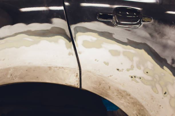 istock Preparation for painting a car element using emery sender by a service technician leveling out before applying a primer after damage to a part of the body in an accident in the vehicle workshop. 1142014348